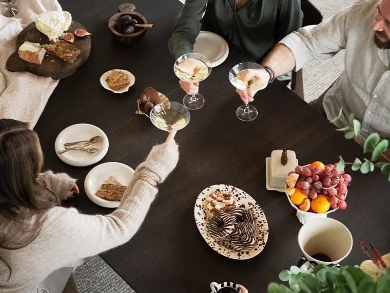 Gathering around Gardner dining table brown oak.
